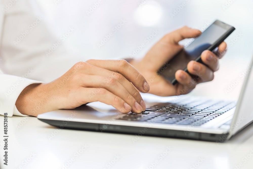 Advertising. Businessman using laptop and mobile phone Advertising. Businessman using laptop and mobile phone