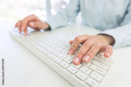 Network. Female office worker typing on the keyboard