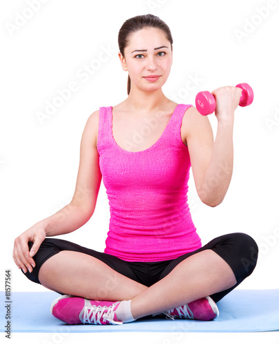 beautiful girl with dumbbells on mat
