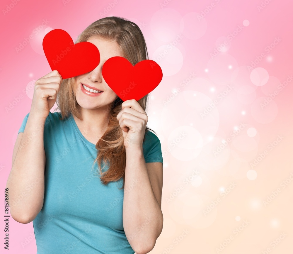 Flirting. Adorable girl with valentines day heart showing love Flirting. Adorable girl with valentines day heart showing love