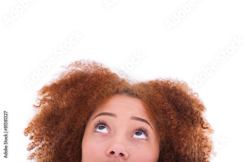 Young hispanic teenage girl looking up isolated on white backgro