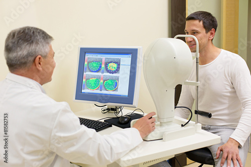 Man having his eyes examined by an eye elderly doctor.