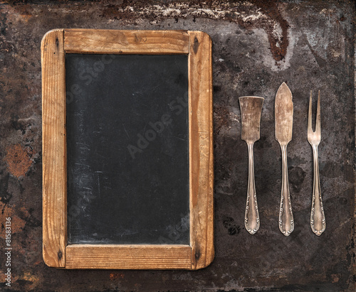 Antique silver cutlery and blackboard for your text. Retro style