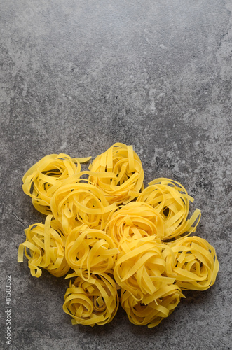 Uncooked tagliatelle pasta on a table