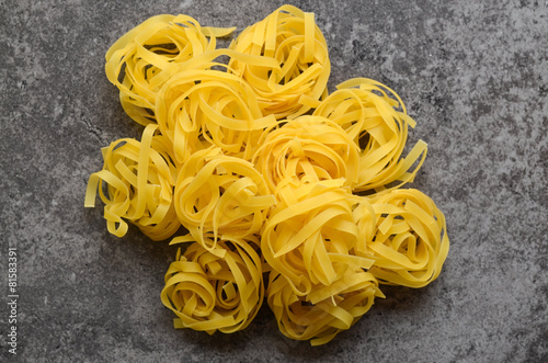 Uncooked tagliatelle pasta on a table