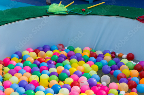 colorful plastic ball floating on water in the pool photo