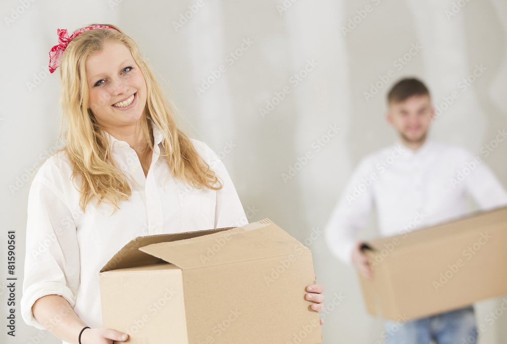 Happy young couple moving in their new home Happy young couple moving in their new home