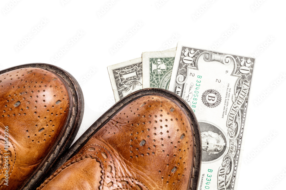 Fototapeta premium Dollars under a pair of Shoes