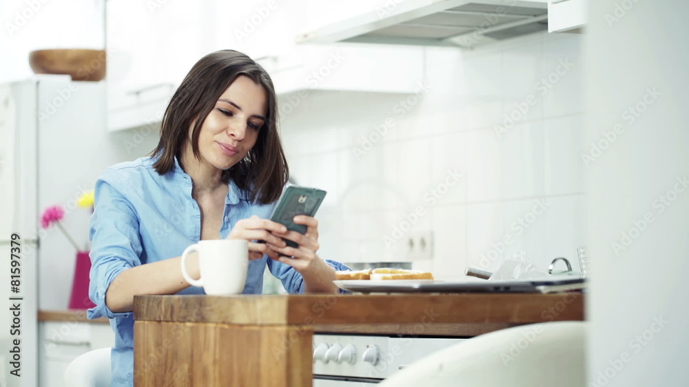 Happy, young woman using smartphone and drinking coffee Happy, young woman using smartphone and drinking coffee