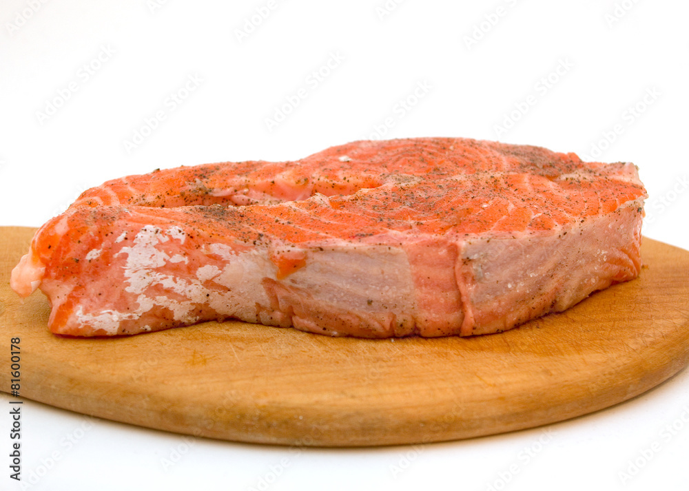 Trout steak on a wooden hardboard ready to cook Trout steak on a wooden hardboard ready to cook