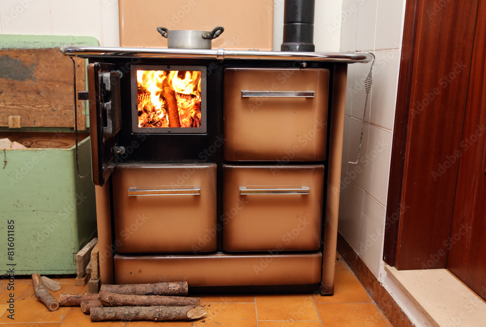 antique stove a wood-burning Stove with fire lit in the old home Stock-Foto  | Adobe Stock