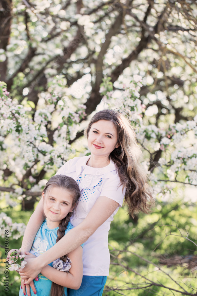 Happy mother with daughter in spring garden Happy mother with daughter in spring garden
