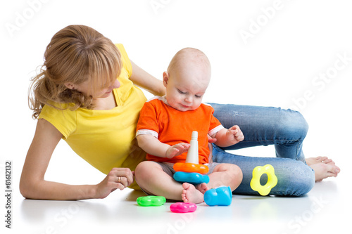 kid boy and mother play together with pyramid toy