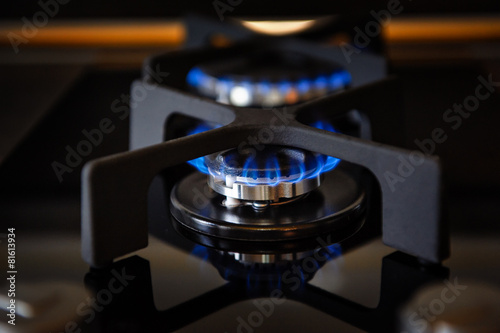Lit gas burner on a glass plate closeup
