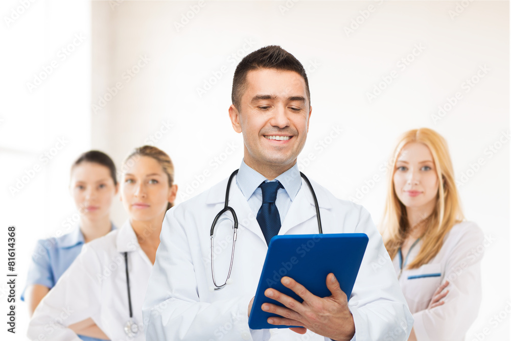 smiling male doctor with tablet pc at hospital smiling male doctor with tablet pc at hospital