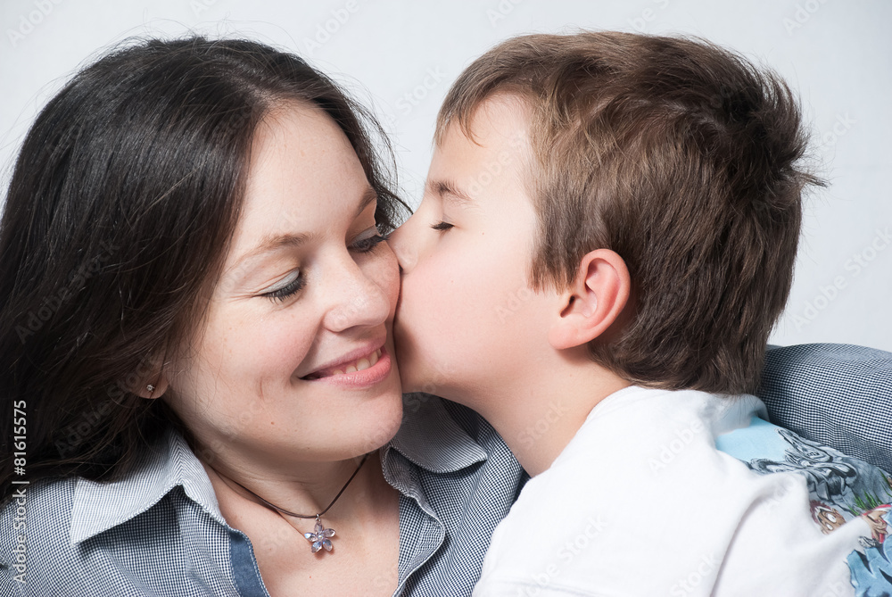 Happy mother with the son isolated on light background Happy mother with the son isolated on light background