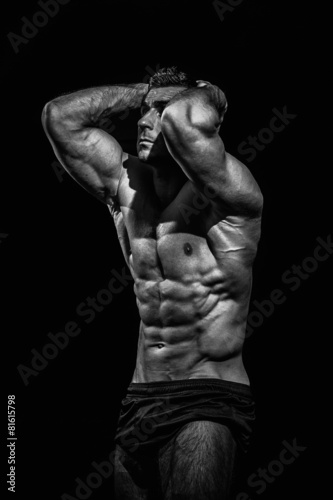 bodybuilder, posing on a black background