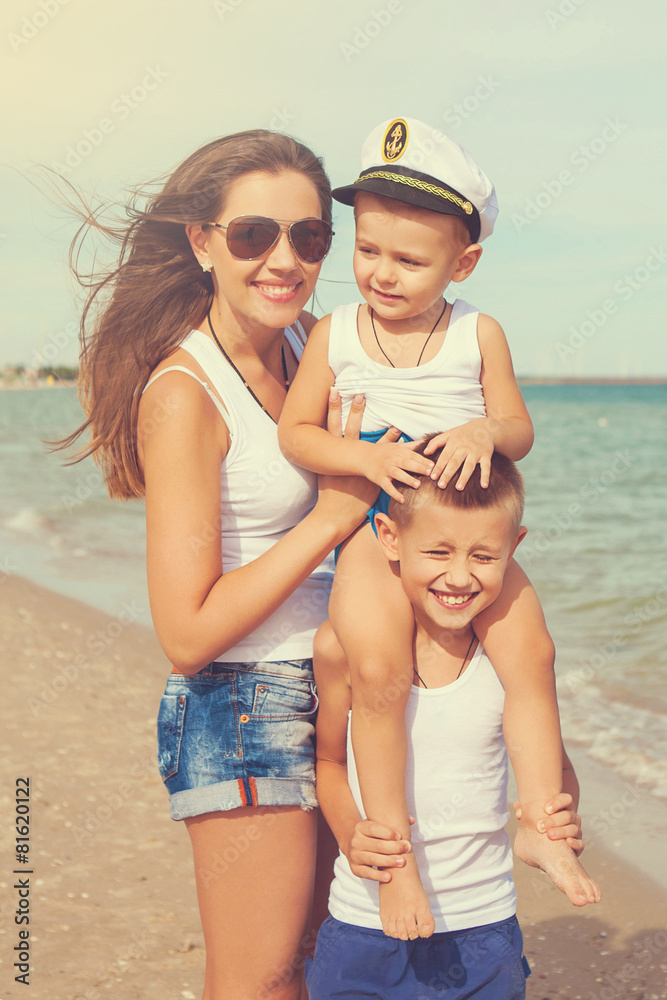 Mother and her two sons having fun on the beach Mother and her two sons having fun on the beach