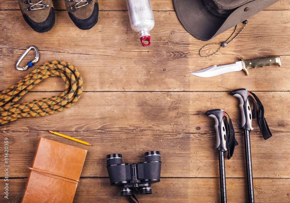Equipment for hiking on a wooden floor background - obrazy, fototapety, plakaty 