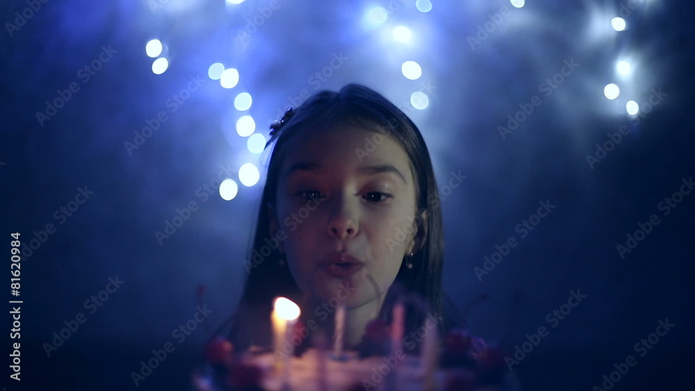 Birthday of girl she blows out candles on cake.