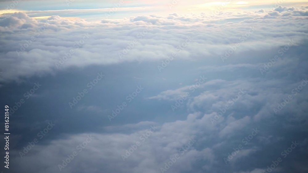 View from airplane of sky and clouds as sun falls down View from airplane of sky and clouds as sun falls down