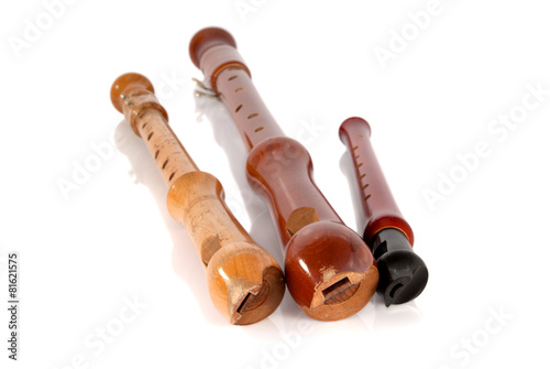 Photos Three old battered wooden recorders isolated on white background