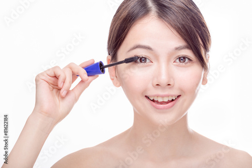 Asian female applying mascara