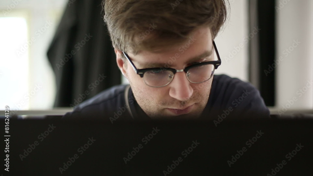 Intelligent man works at the computer in studio Intelligent man works at the computer in studio