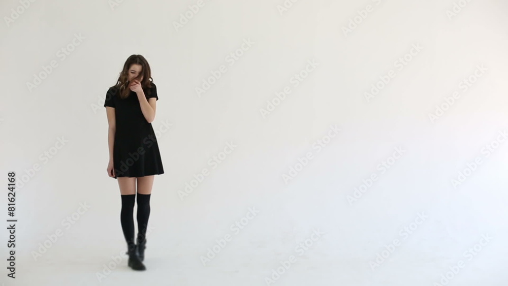 Woman flirts looking at camera white studio background Woman flirts looking at camera white studio background