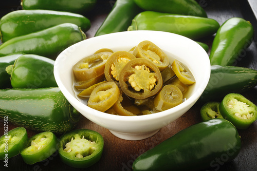 pickled sliced green jalapeno peppers in white bowl