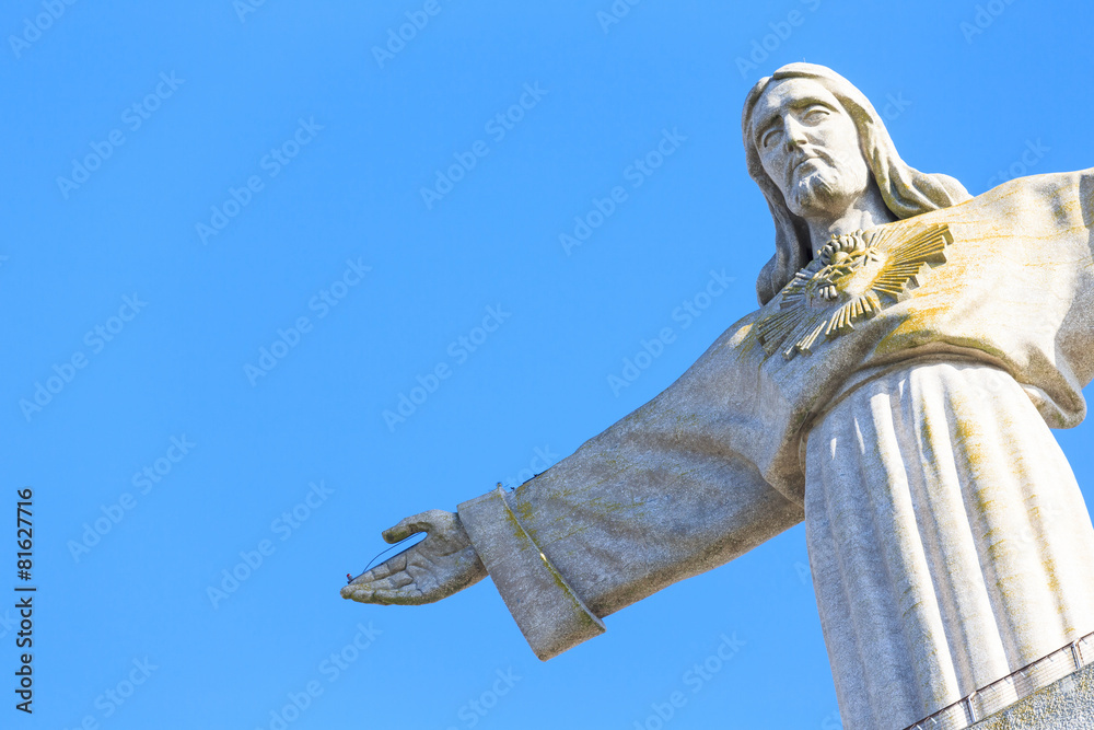 the statue of Jesus, in Almada; Across the river from Lisbon, Po - obrazy, fototapety, plakaty 