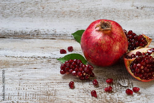 Ripe juicy pomegranate on wooden table