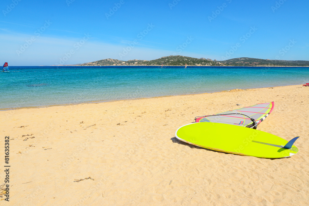 windsurf board on a golden beach windsurf board on a golden beach