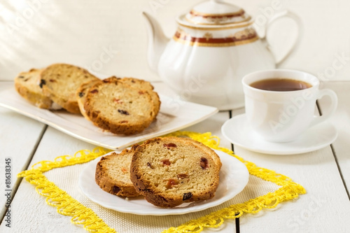 Cake with raisins  teapot and a cup of tea