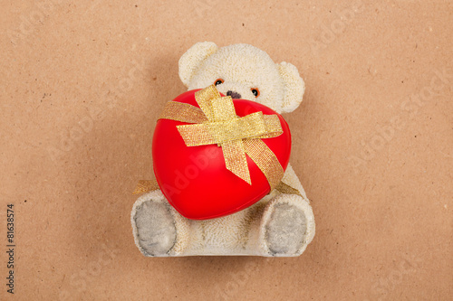 Teddy bear with a heart on vintage background