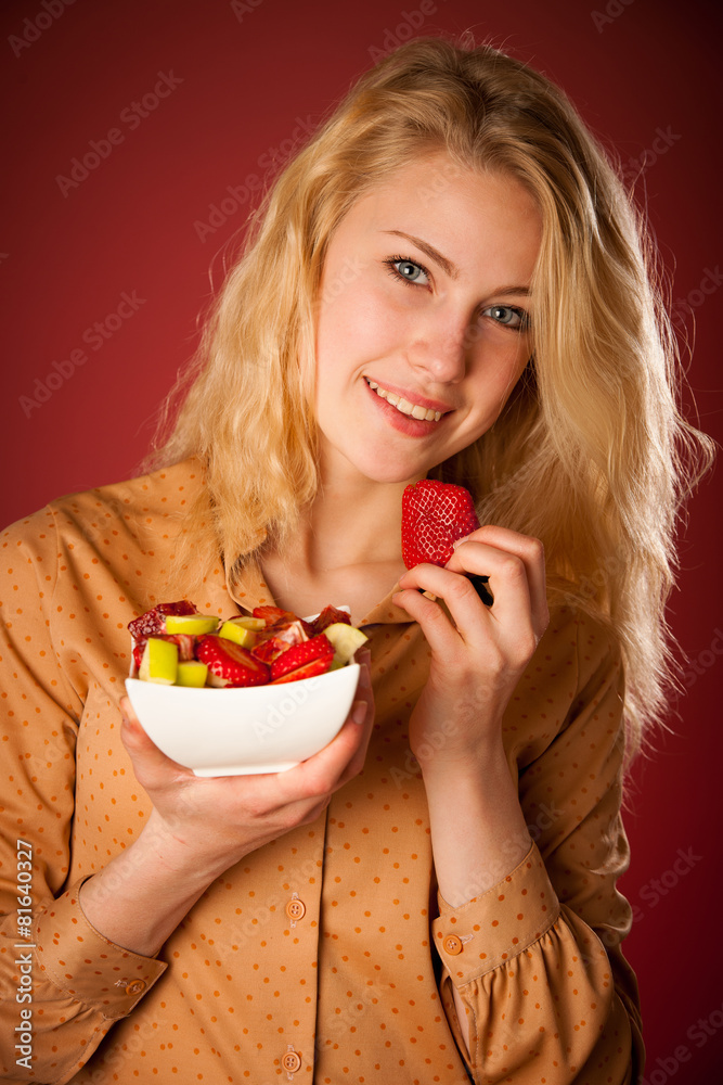 Beautiful young caucasian blonde woman holds a delicious fruit s Beautiful young caucasian blonde woman holds a delicious fruit s
