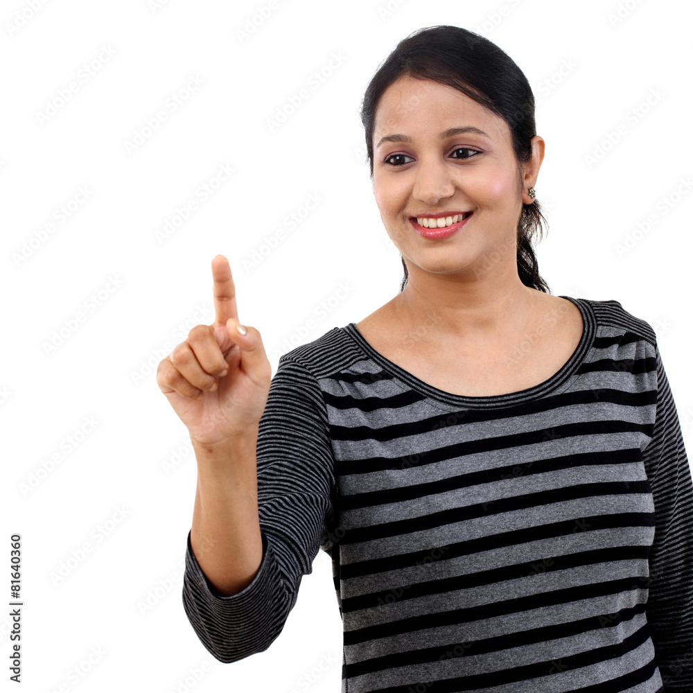 Cheerful young woman pointing on a virtual screen Cheerful young woman pointing on a virtual screen
