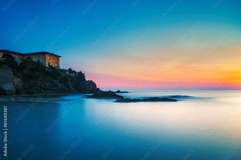 Castiglioncello old building on the rocks and sea on sunset. Tus