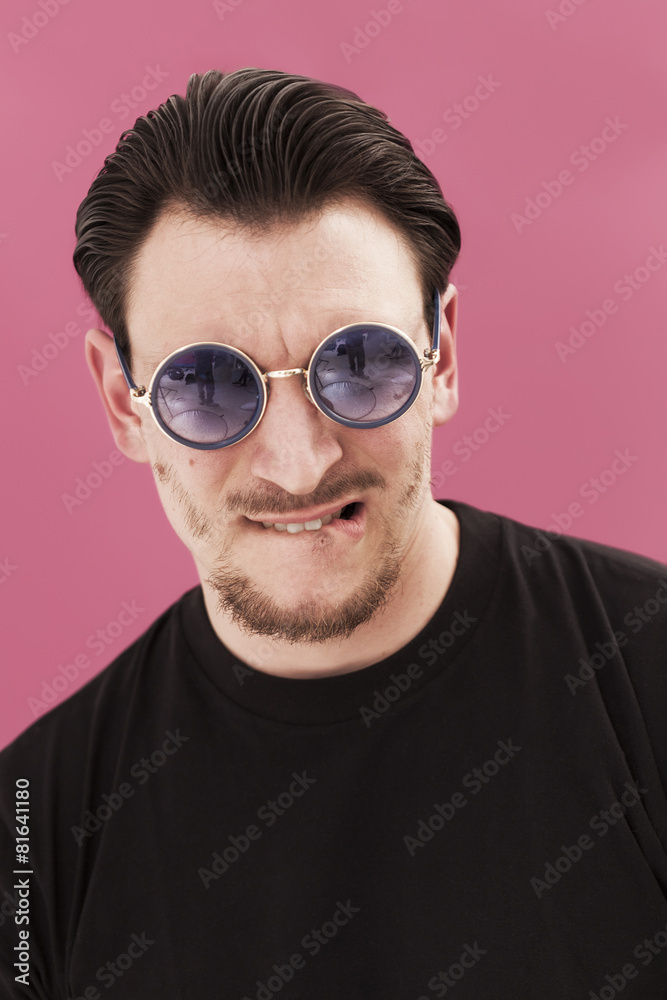 Handsome man portrait biting his lip and wearing sunglasses Handsome man portrait biting his lip and wearing sunglasses