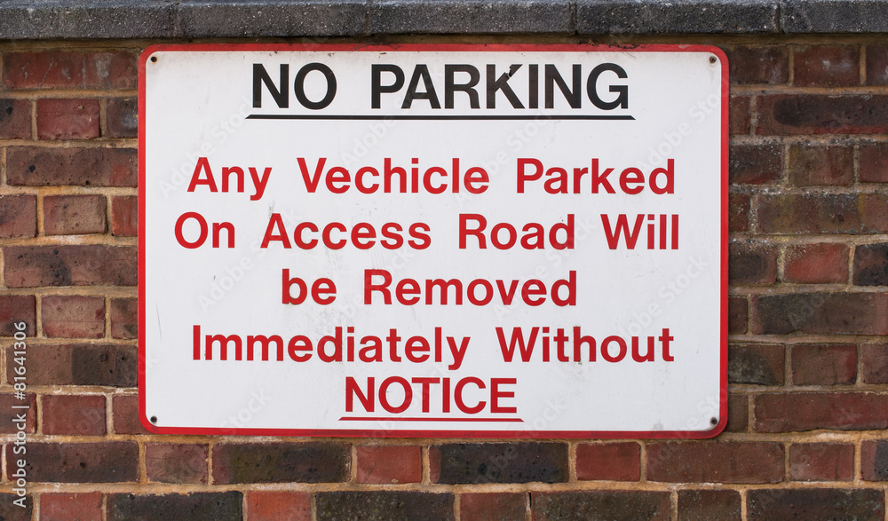 NO PARKING sign on very old brick wall - Tooting, London, UK