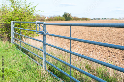 Side view of closed farmland metal gate in England