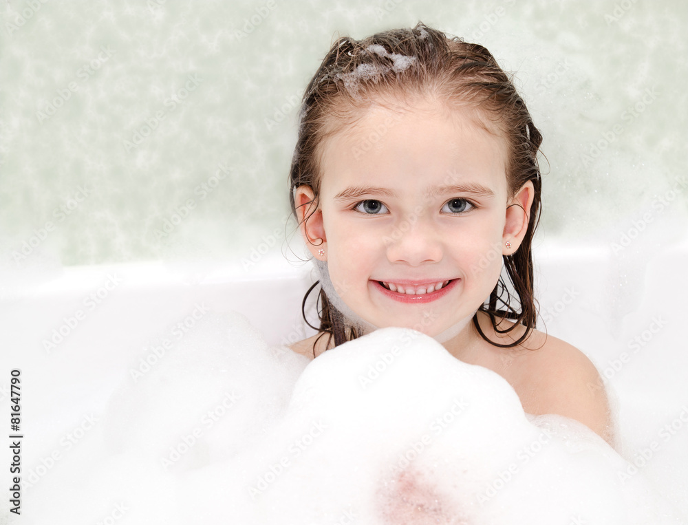 Smiling little girl washing in bath Stock Photo | Adobe Stock