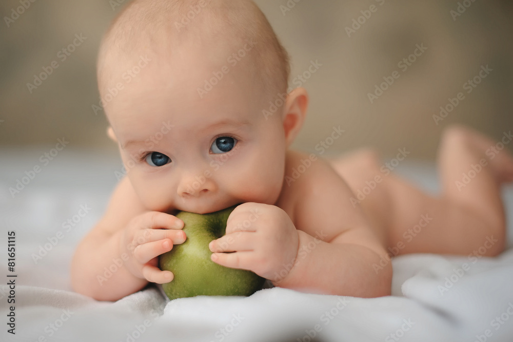 Cute baby with a huge green apple, health, lifestyle Cute baby with a huge green apple, health, lifestyle