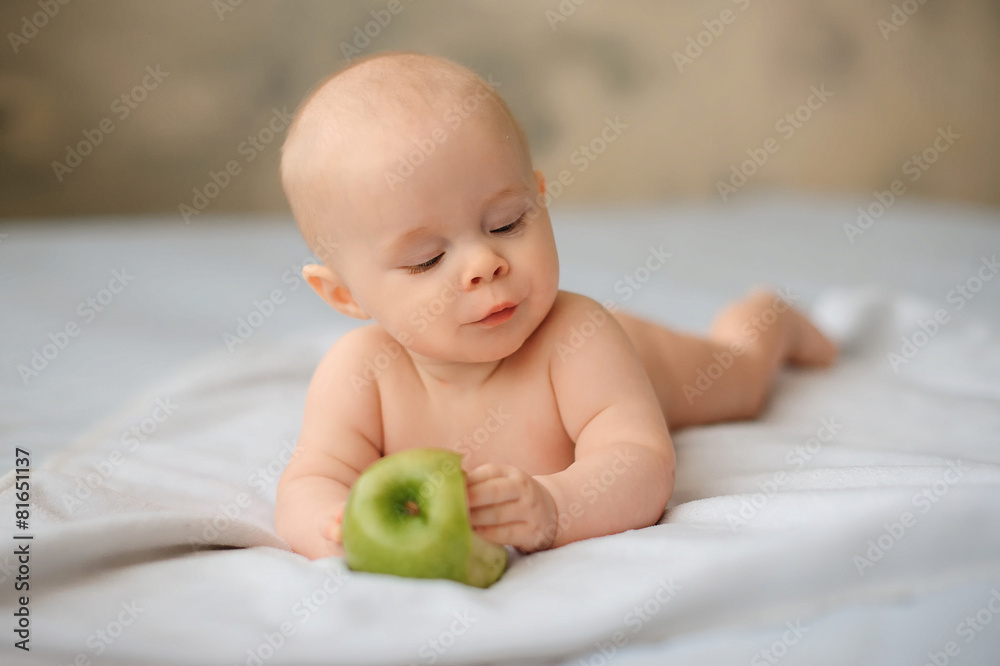 Cute baby with a huge green apple, health, lifestyle Cute baby with a huge green apple, health, lifestyle