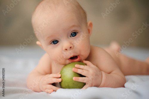 Cute baby with a huge green apple, health, lifestyle