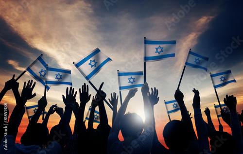 Silhouettes of People Holding Flag of Israel Concept photo