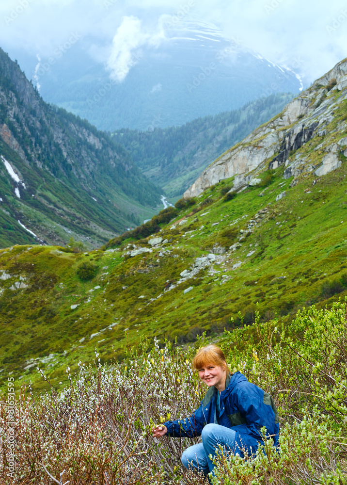 Woman in summer mountain (St. Gotthard Pass, Switzerland).