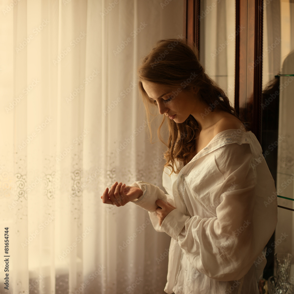portrait of a beautiful blonde with long hair in a shirt at home portrait of a beautiful blonde with long hair in a shirt at home