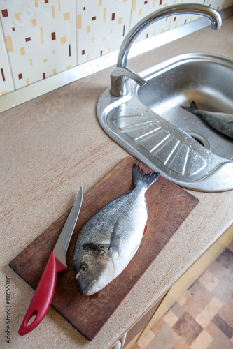 Fototapeta Naklejka Na Ścianę i Meble -  Doradi fish on kitchen table
