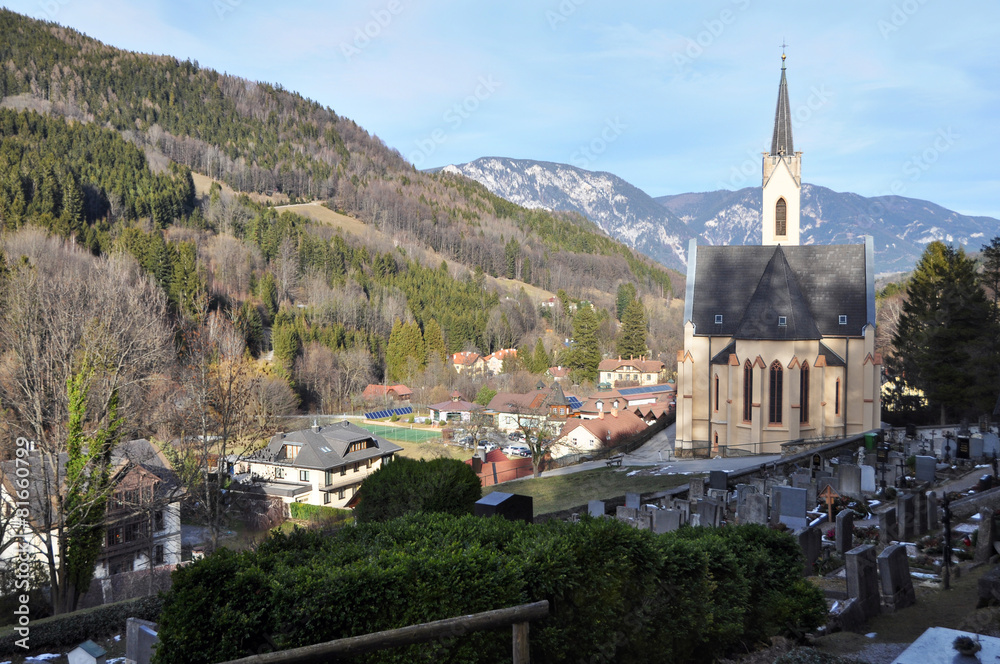 Church and cemetery in the alpine village Prein an der Rax. Austria